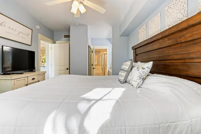 a bedroom with a bed and a flat screen tv