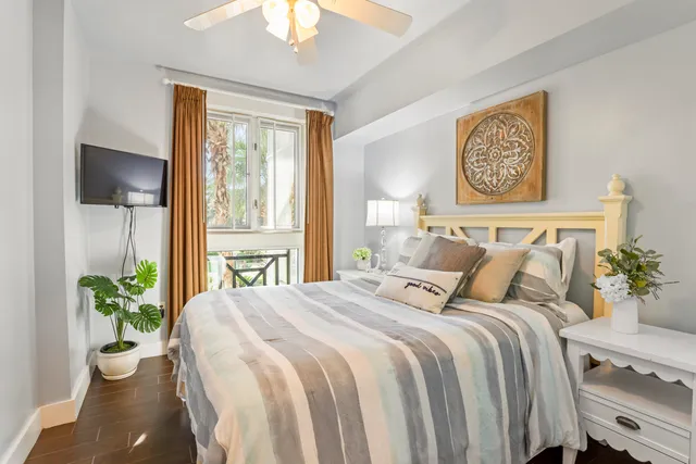 a bedroom with a bed and a potted plant