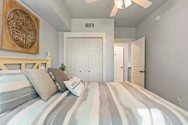 a bedroom with a large bed and a painting on the wall