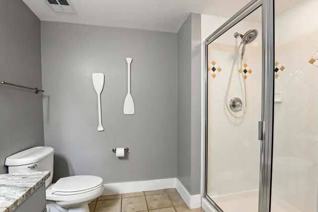 a bathroom with a toilet and a shower