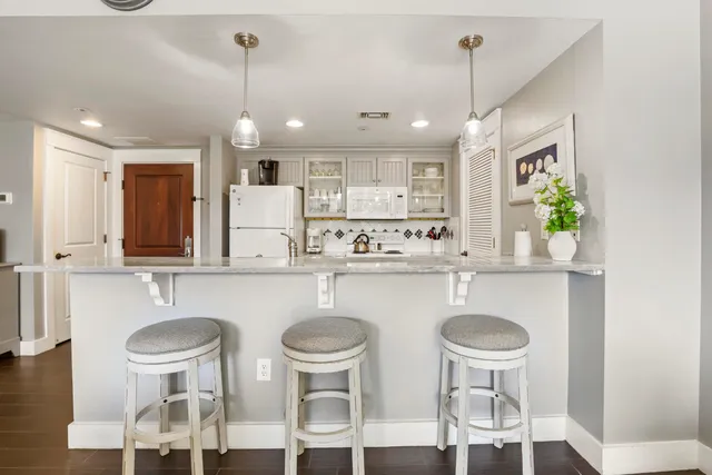 a kitchen with stainless steel appliances granite countertop a sink and a refrigerator
