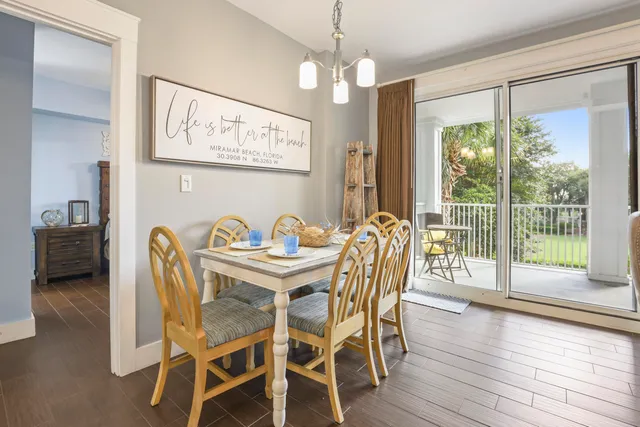 a dining room with furniture a chandelier and wooden floor