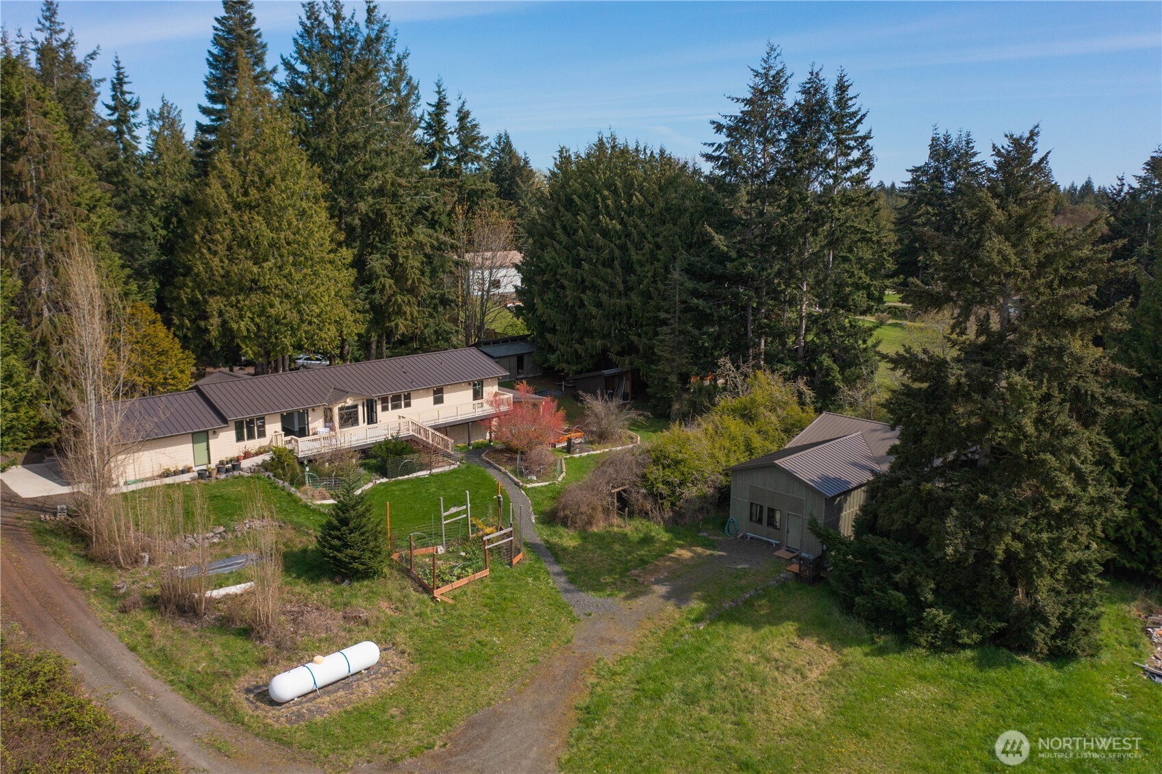 an aerial view of a house with yard swimming pool and outdoor seating