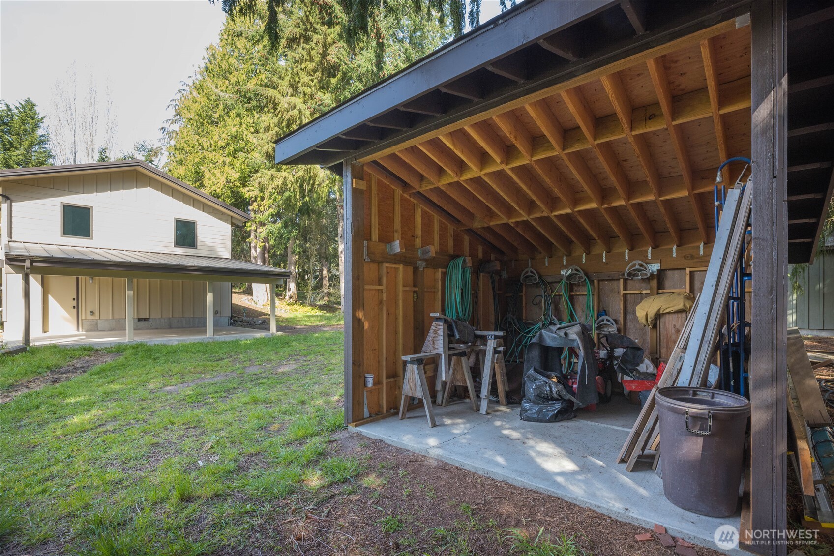 254 Simpson Road Sequim, WA 98382 - Photo 30 of 40 a view of a backyard with table and chairs and wooden fence