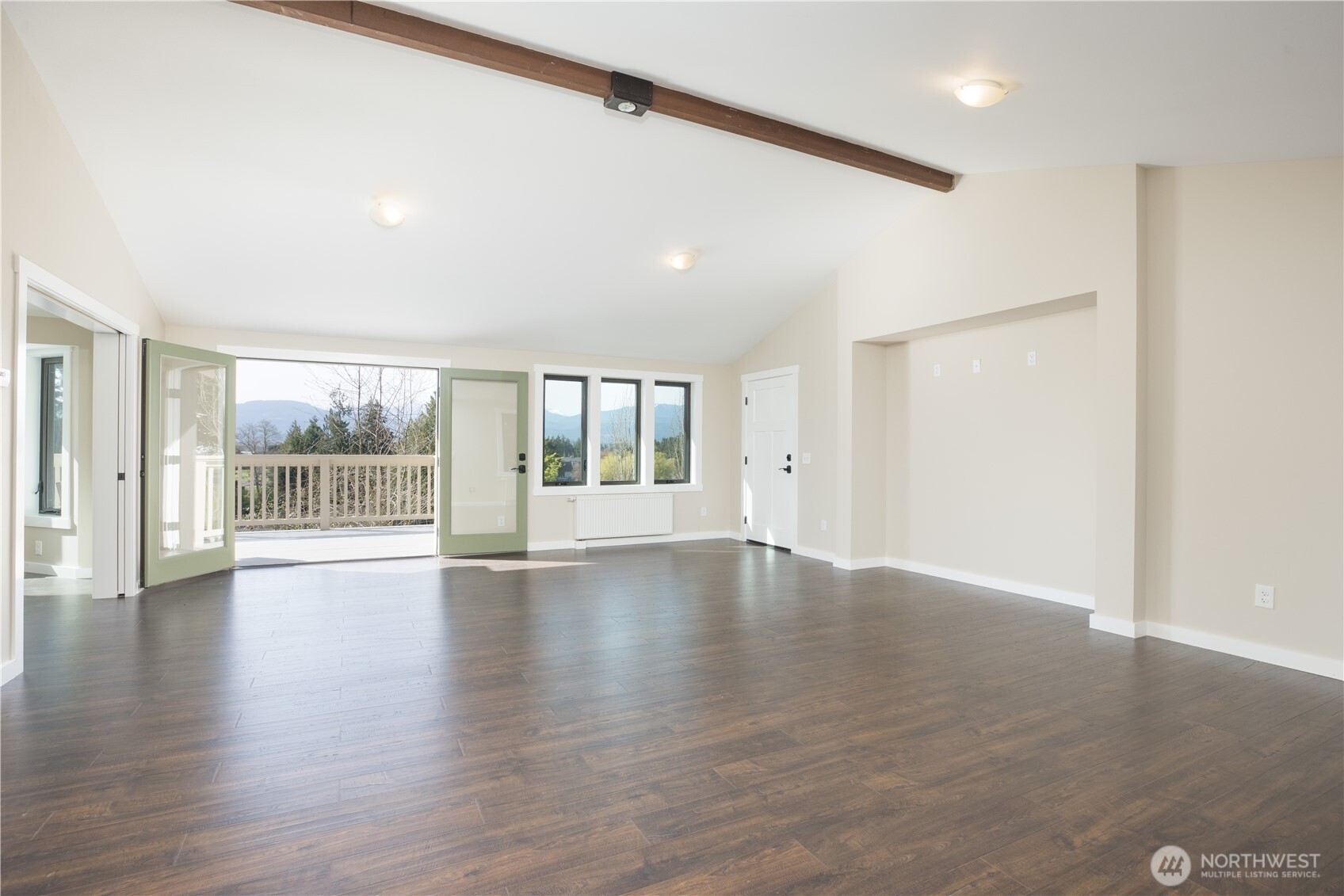 254 Simpson Road Sequim, WA 98382 - Photo 4 of 40 a view of an empty room with wooden floor and a window