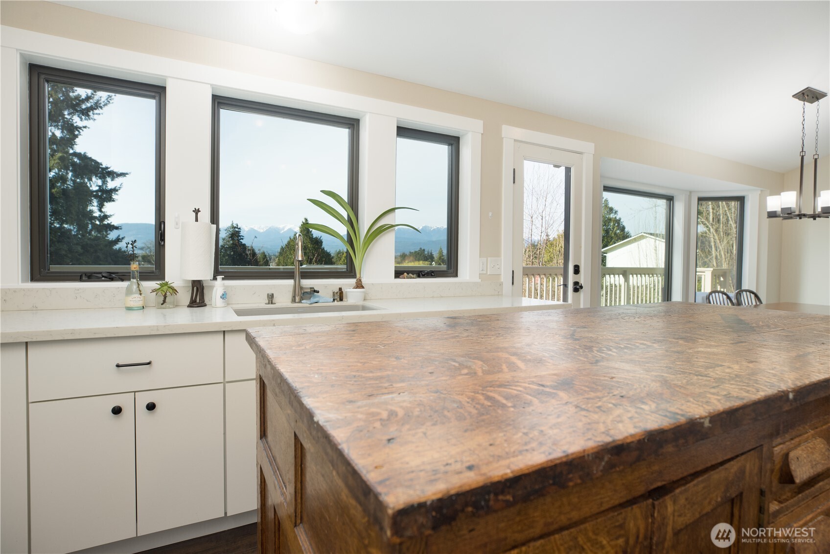 254 Simpson Road Sequim, WA 98382 - Photo 8 of 40 a kitchen with a sink a counter top space and living room view