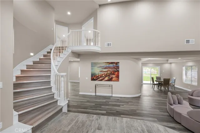 a view of entryway and hall with wooden floor