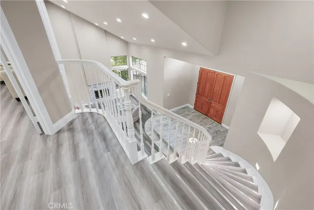 a view of entryway and hall with wooden floor