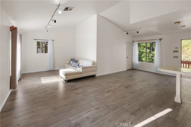 a spacious bedroom with a bed and a window