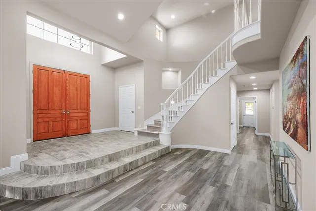 a view of entryway and hall with wooden floor