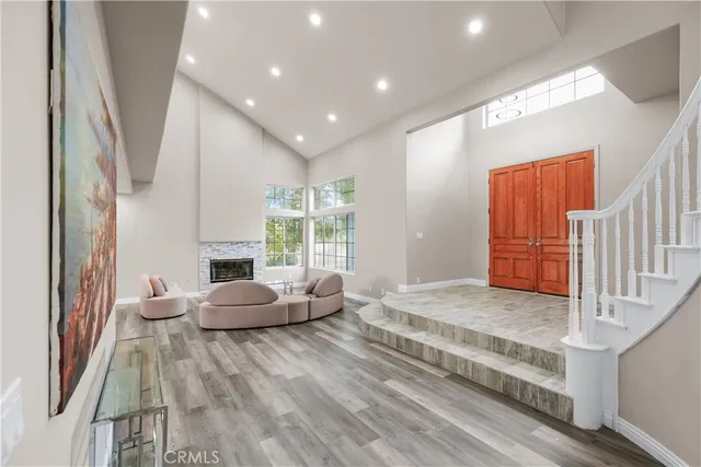 a bedroom with furniture and a large window