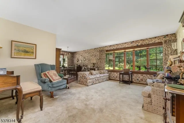 a living room with furniture a fireplace and a large window