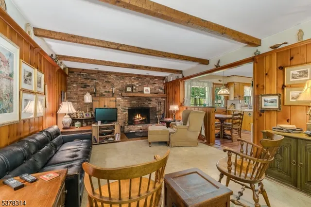 a living room with furniture a fireplace and a large window