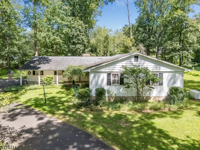 a backyard of a house with yard and trampoline