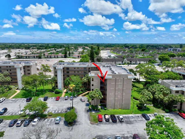 a view of a garden with a building in the background