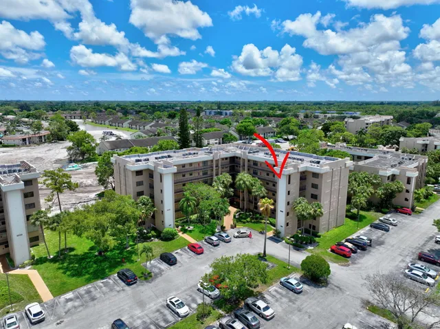 a view of a garden with a building in the background