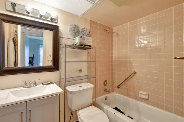 a bathroom with a sink toilet mirror and shower