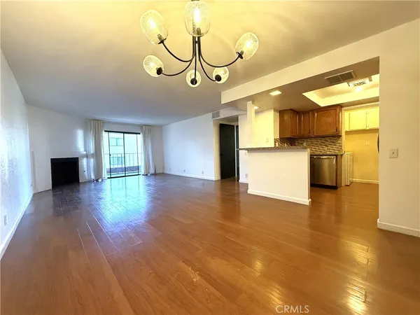 a view of a kitchen with a sink and wooden floor