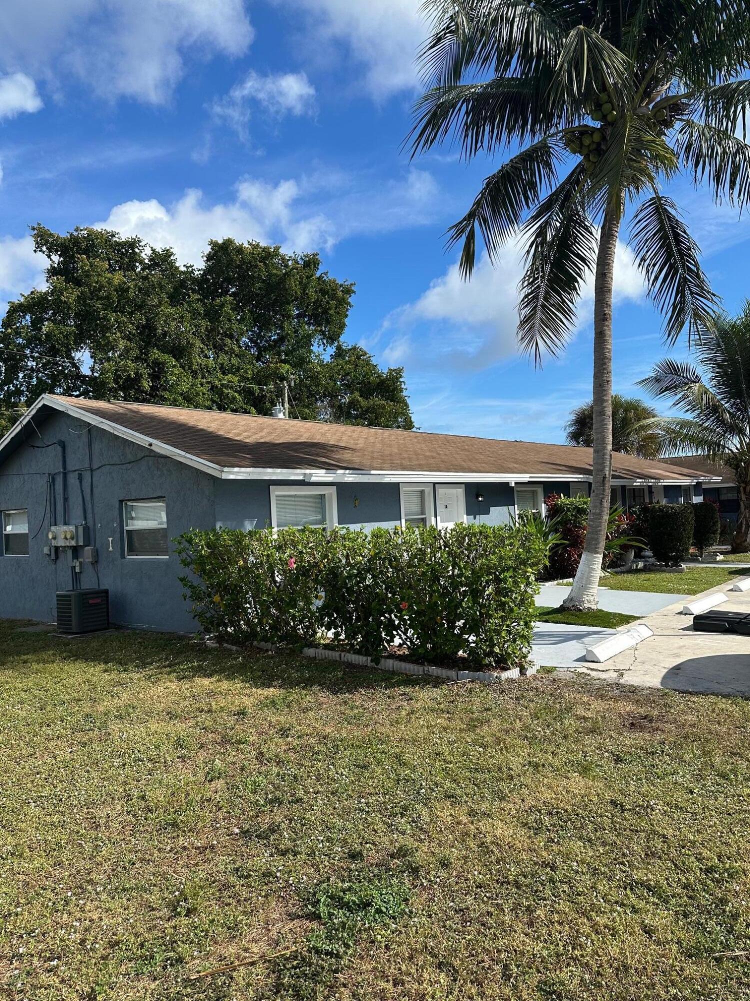 4810 Davis Road, Unit 4814 Lake Worth, FL 33461 - Photo 2 of 14 a view of a garden with a fountain