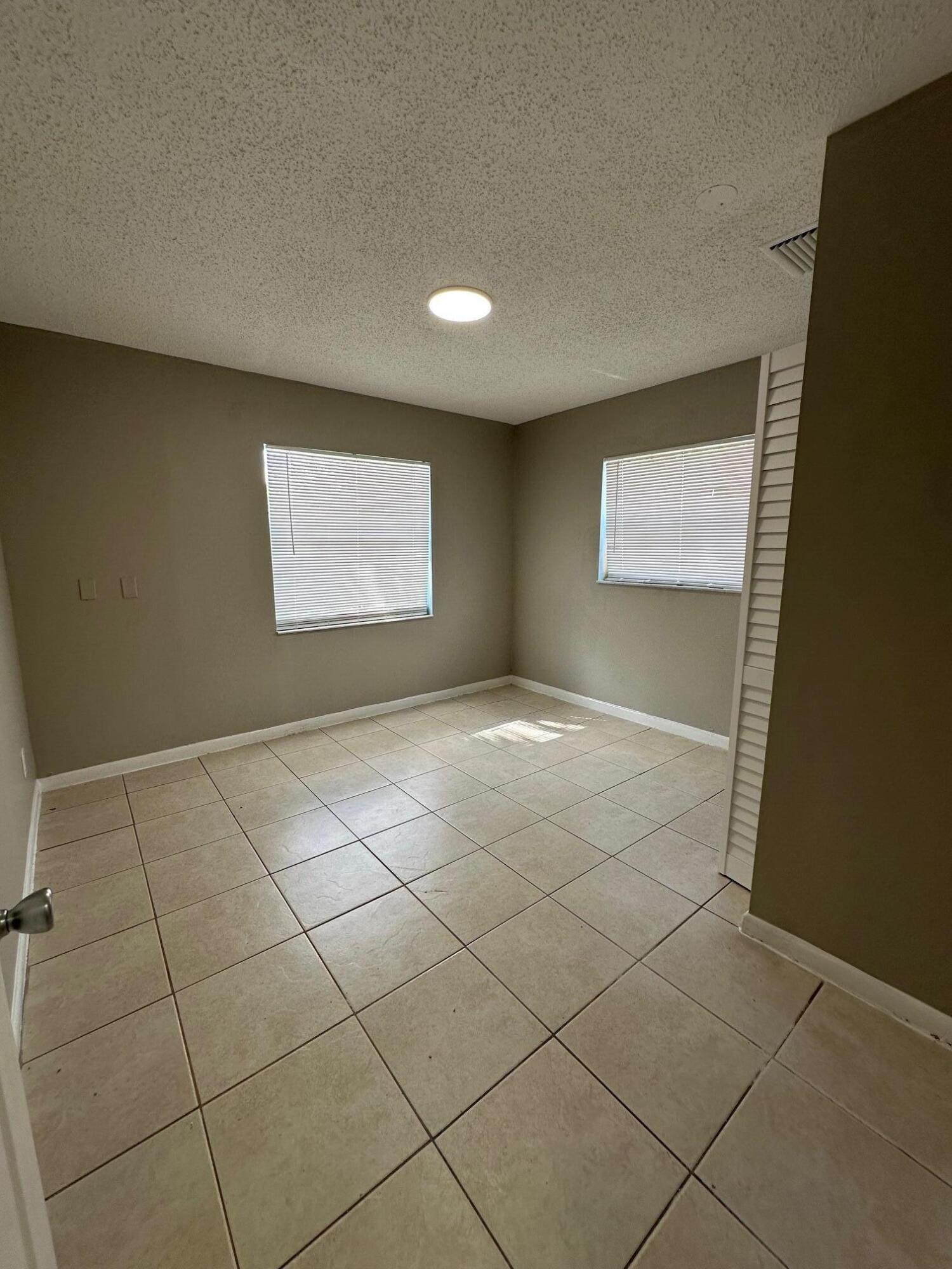 4810 Davis Road, Unit 4814 Lake Worth, FL 33461 - Photo 7 of 14 a view of an empty room and window
