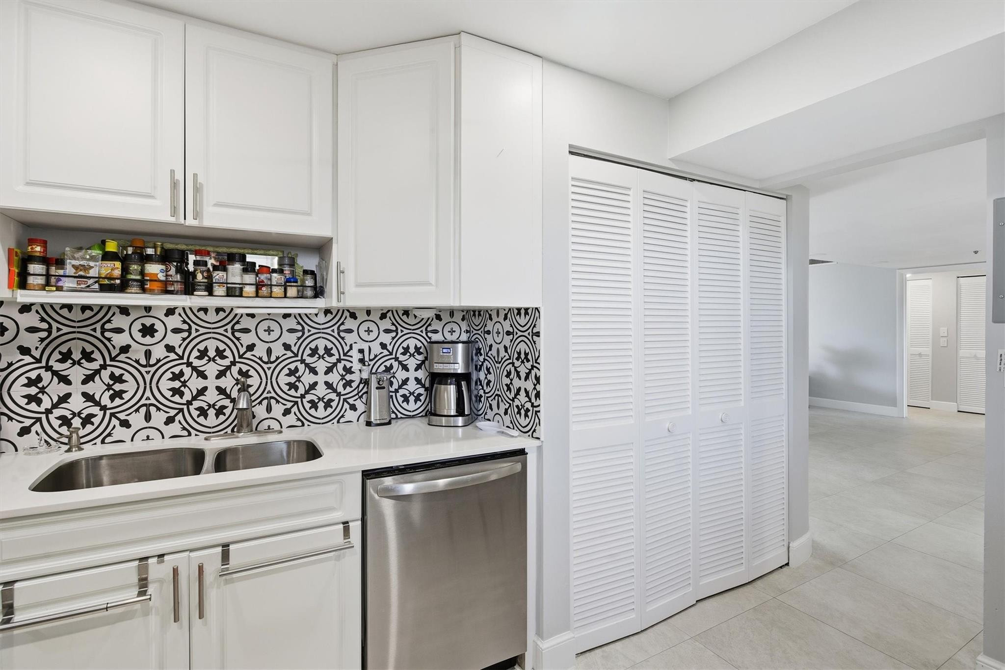 3910 Inverrary Boulevard, Unit 708B Lauderhill, FL 33319 - Photo 17 of 58 a kitchen with white cabinets and white appliances
