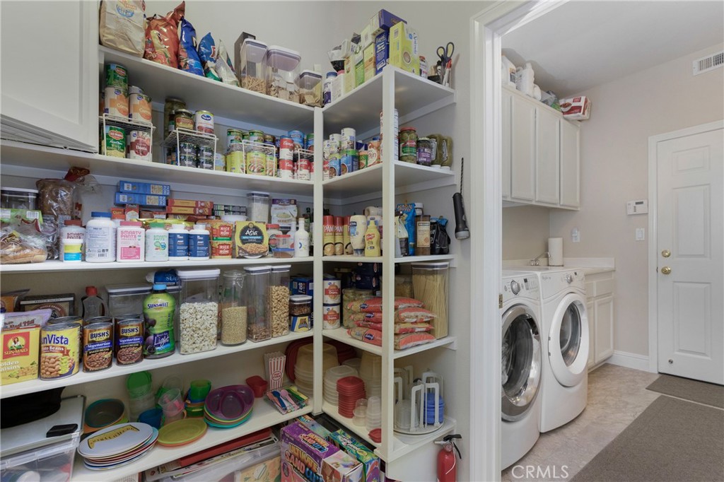 28 Rosenblum Irvine, CA 92602 - Photo 11 of 25 a view of walk in closet with clothes and shoes