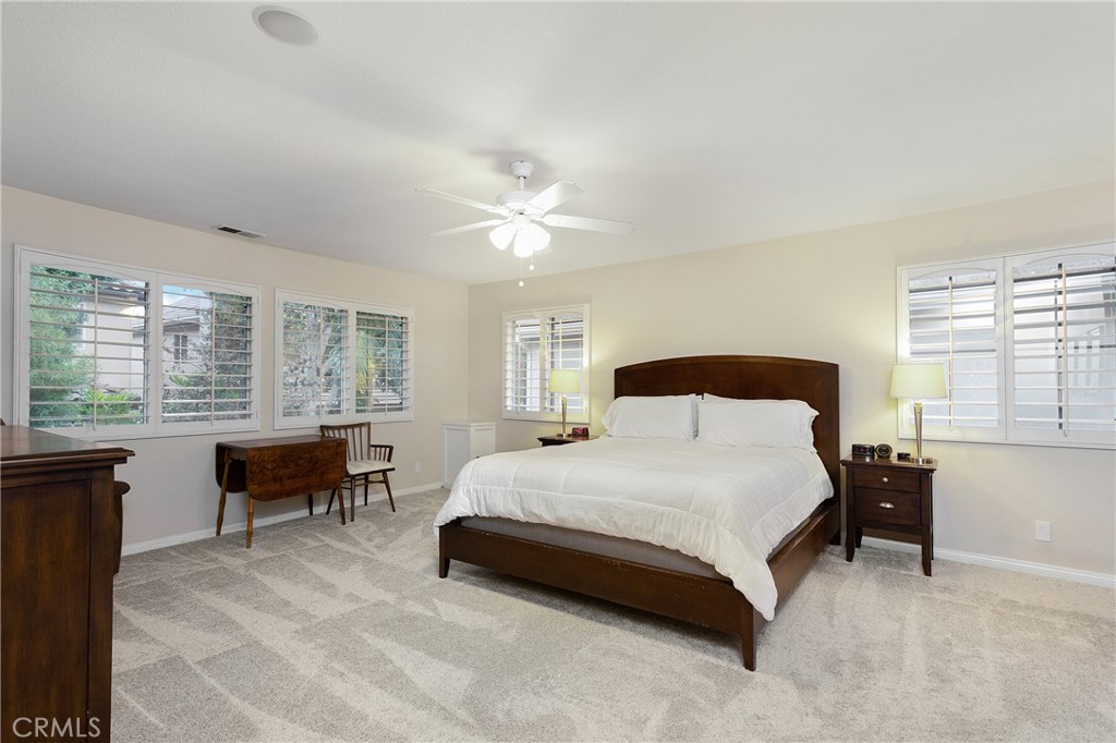 28 Rosenblum Irvine, CA 92602 - Photo 15 of 25 a spacious bedroom with a bed a table and a large window