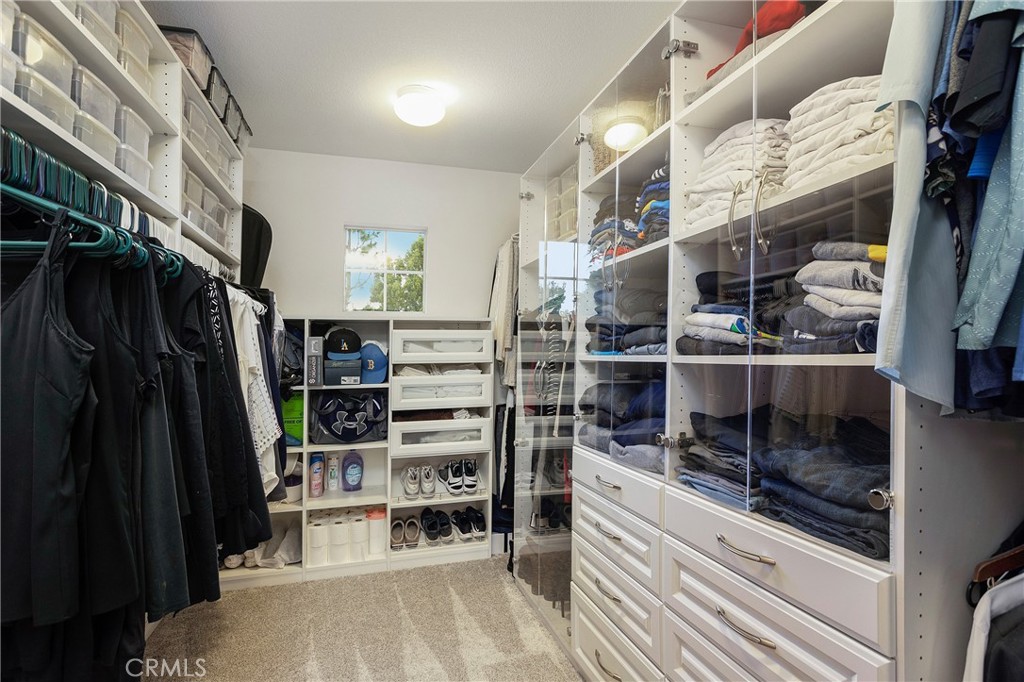 28 Rosenblum Irvine, CA 92602 - Photo 17 of 25 a view of walk in closet with clothes and shoes