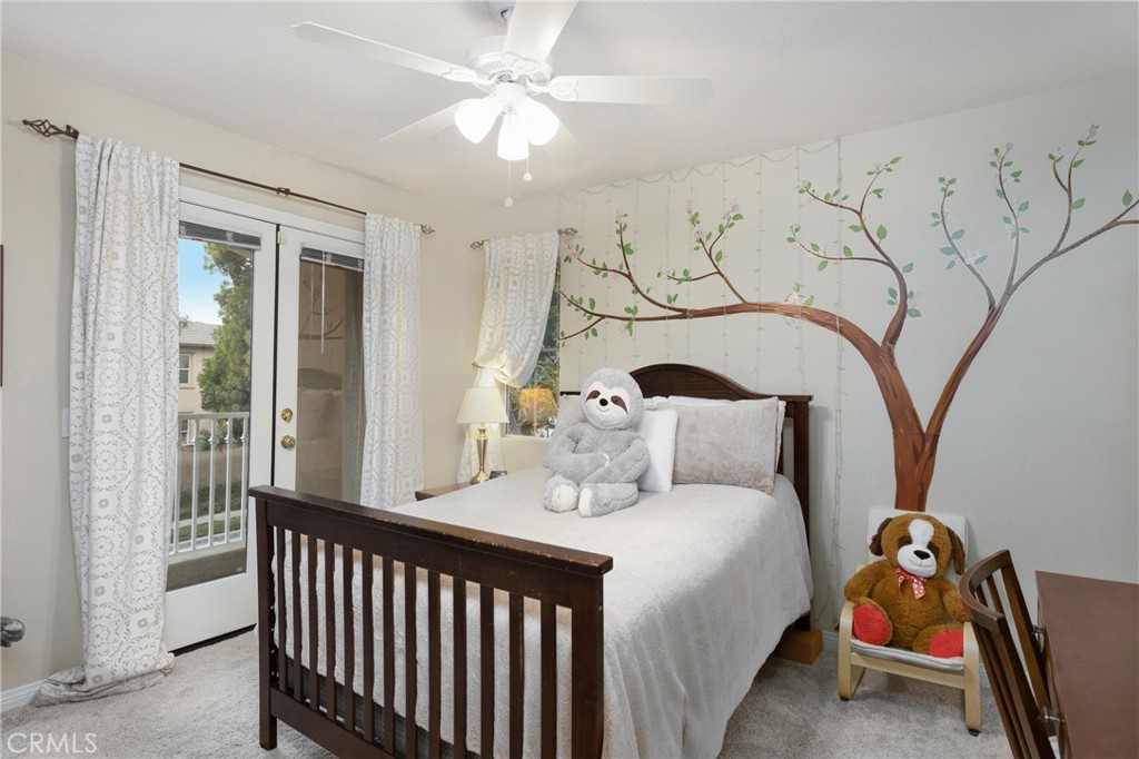 28 Rosenblum Irvine, CA 92602 - Photo 18 of 25 a bedroom with a bed and a chandelier