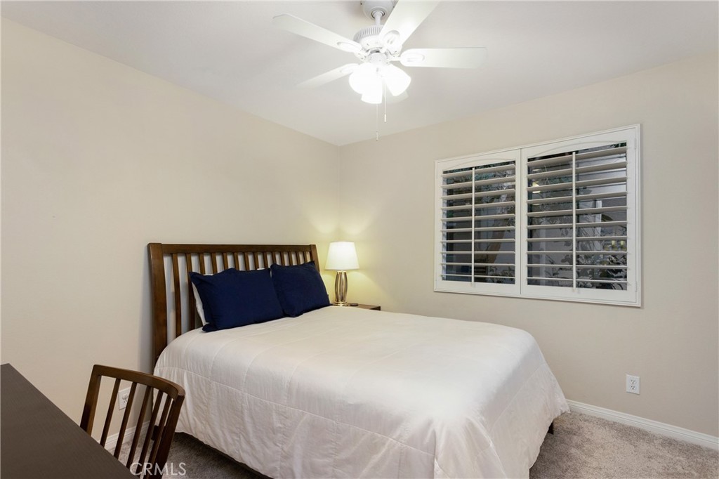 28 Rosenblum Irvine, CA 92602 - Photo 20 of 25 a bedroom with a large bed and a chandelier