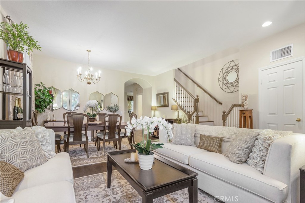 28 Rosenblum Irvine, CA 92602 - Photo 2 of 25 a living room with furniture chandelier and a large window
