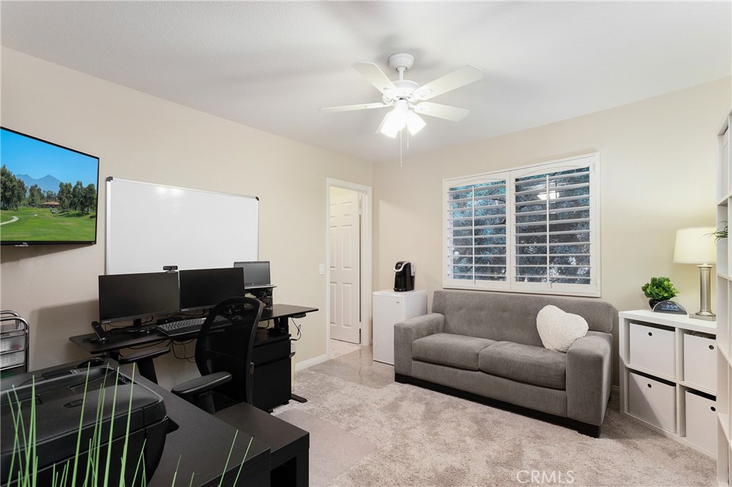 28 Rosenblum Irvine, CA 92602 - Photo 21 of 25 a living room with furniture and a flat screen tv