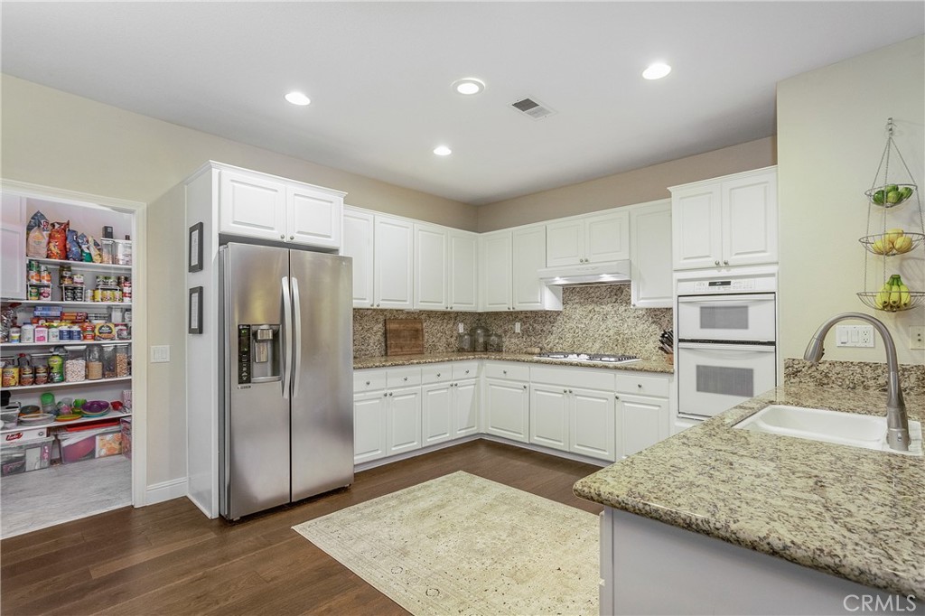 28 Rosenblum Irvine, CA 92602 - Photo 8 of 25 a kitchen with stainless steel appliances granite countertop a refrigerator and a sink