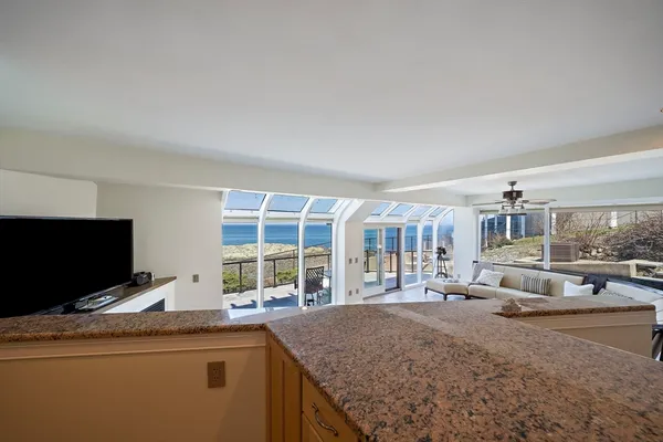 a kitchen with kitchen island granite countertop a sink and a stove