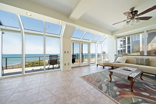 a living room with furniture and a floor to ceiling window