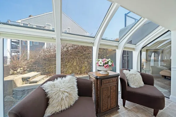 a bedroom with furniture and a large window