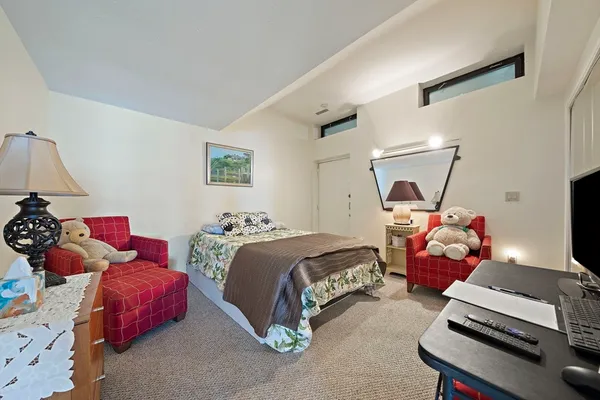 a bedroom with bed and a window