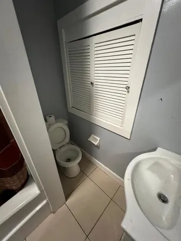 a bathroom with a toilet and a mirror