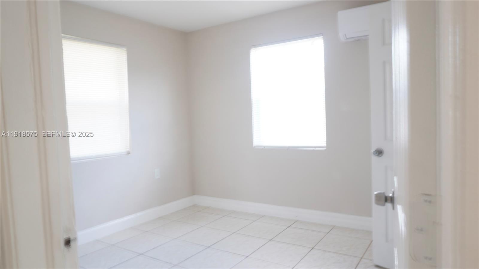 13701 Southwest 266th Street, Unit 13701 Homestead, FL 33032 - Photo 5 of 10 a view of an empty room and window