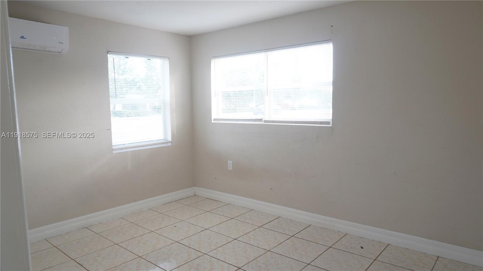 13701 Southwest 266th Street, Unit 13701 Homestead, FL 33032 - Photo 7 of 10 an empty room with a window