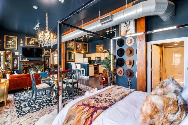 a view of a patio with table and chairs with wooden fence and large trees