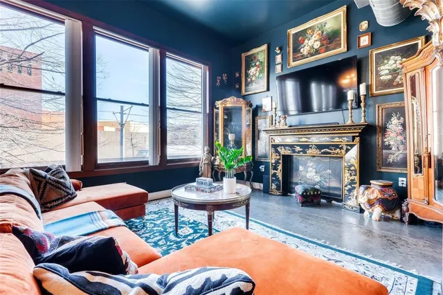 a living room with furniture a chandelier and a dining table