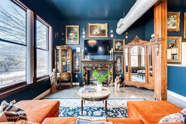 a living room with furniture a flat screen tv and a fireplace