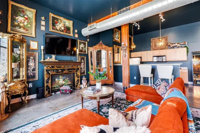 a kitchen with stainless steel appliances kitchen island granite countertop a table and chairs in it