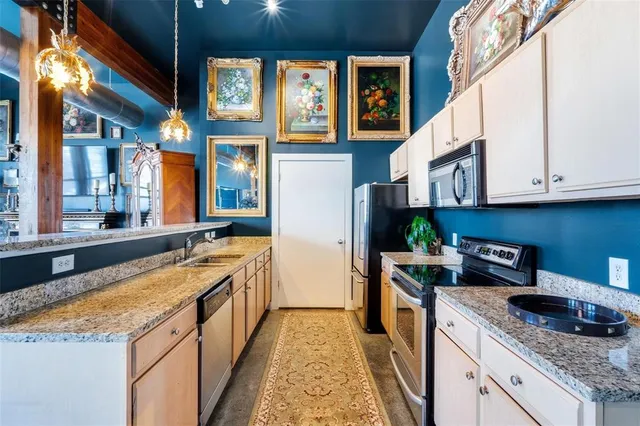 a living room with furniture a chandelier and a dining table