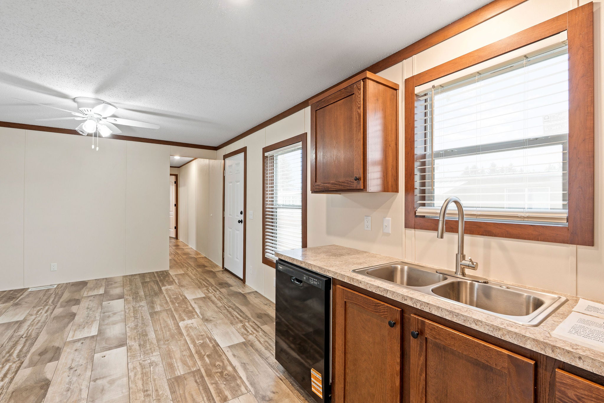 110 Van Sant Road, Unit 15 Kalispell, MT 59901 - Photo 12 of 22 Stainless steel double sink with a modern pulldown faucet and a view into the living area