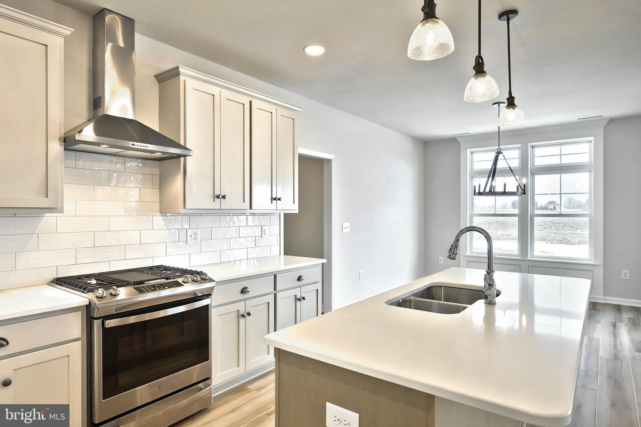 535 Lumber Street Littlestown, PA 17340 - Photo 40 of 40 a kitchen with granite countertop a sink a stove and cabinets