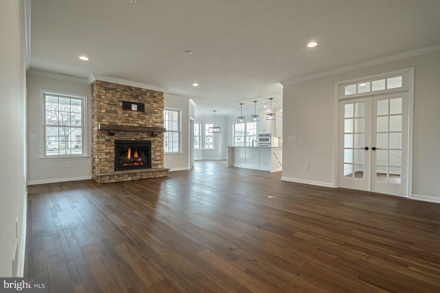 535 Lumber Street Littlestown, PA 17340 - Photo 4 of 40 an empty room with wooden floor fireplace and windows