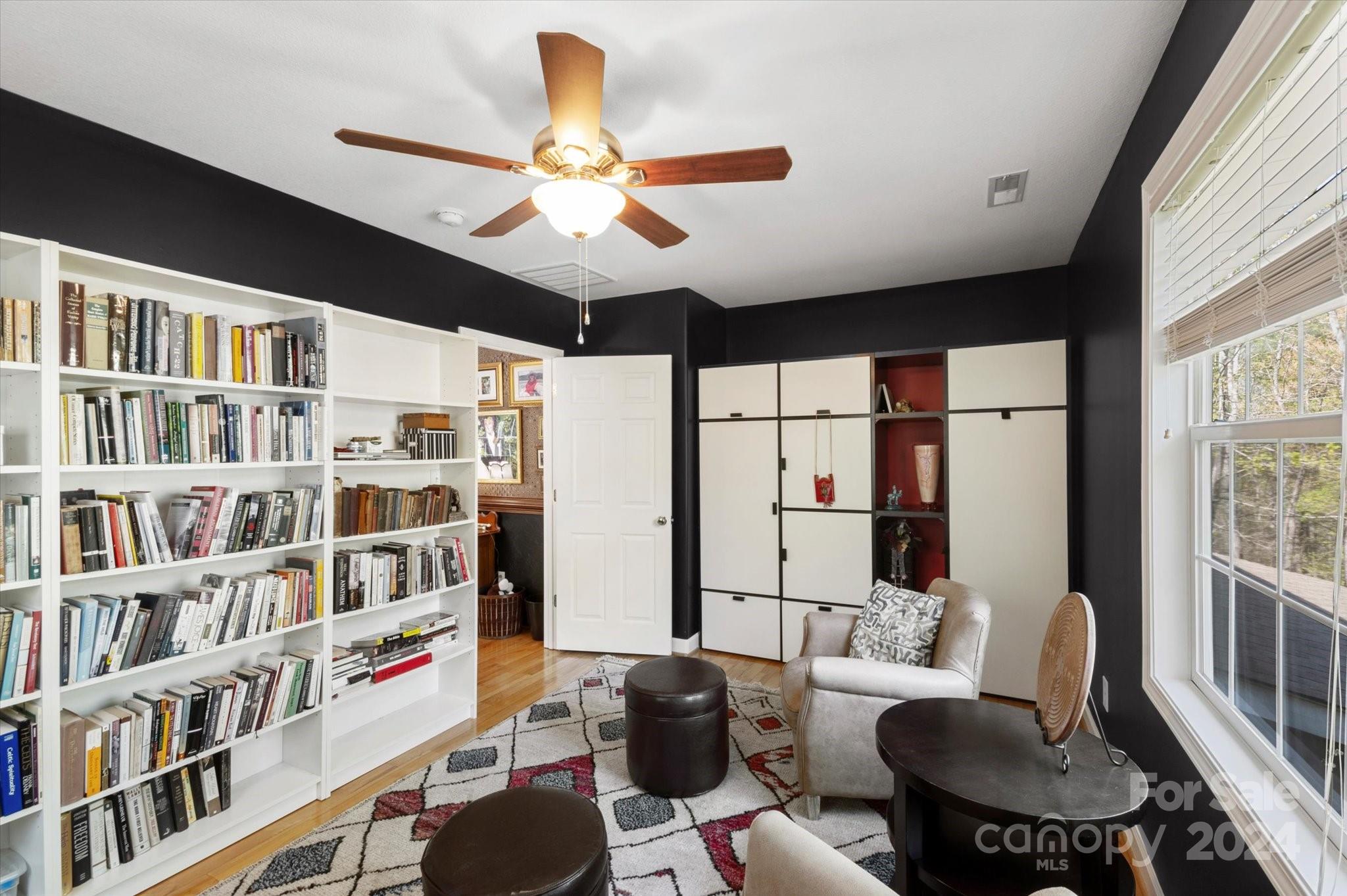 16 Leisure Loop Weaverville, NC 28787 - Photo 26 of 44 a living room with furniture a bookshelf and a large window