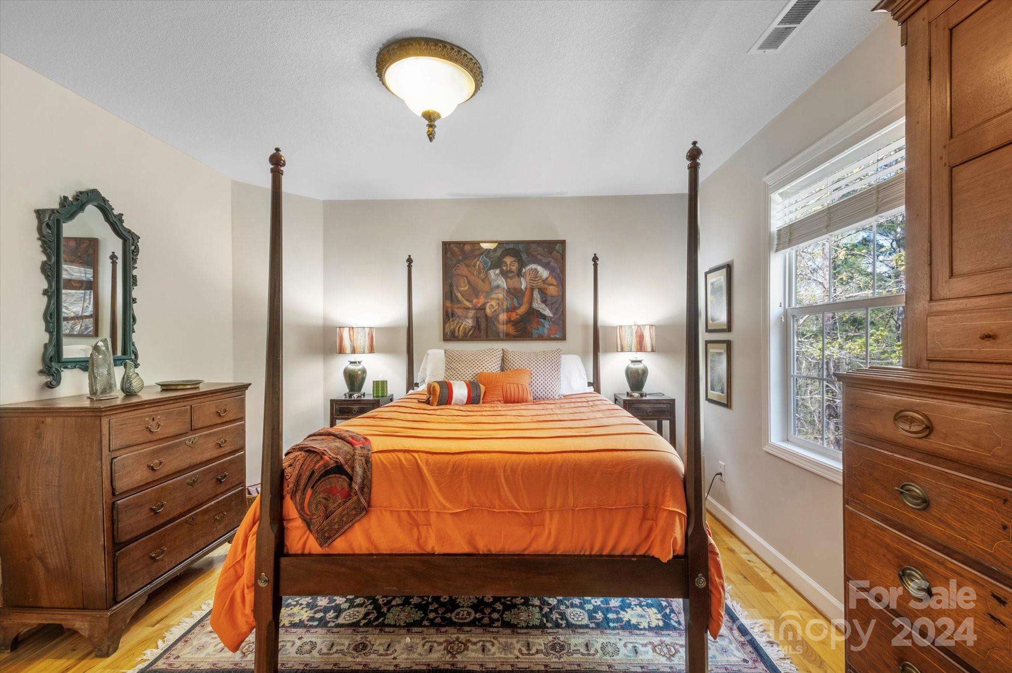 16 Leisure Loop Weaverville, NC 28787 - Photo 30 of 44 a bedroom with a bed and wooden floor